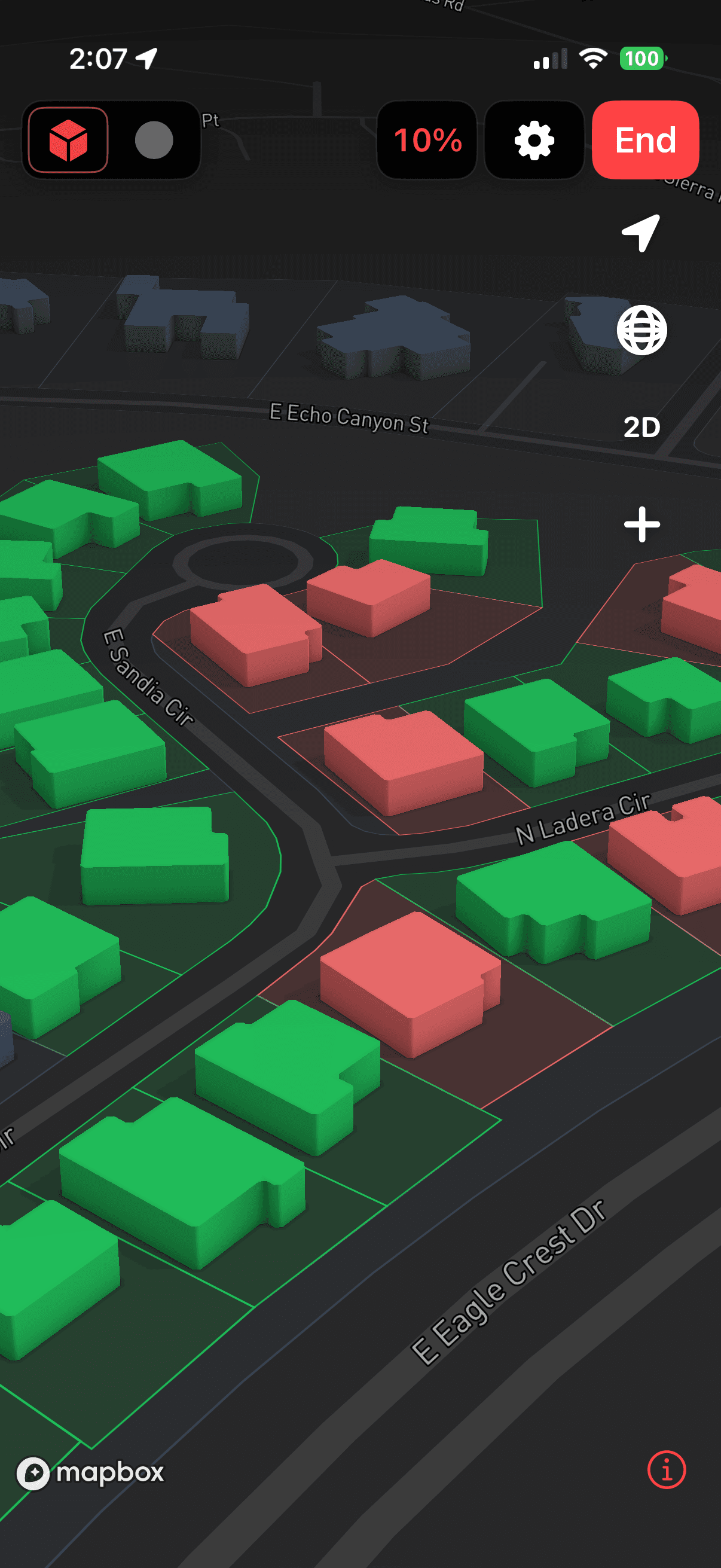 WolfGrid on iPhone showing a 3D neighborhood map with green and red buildings and outlined properties